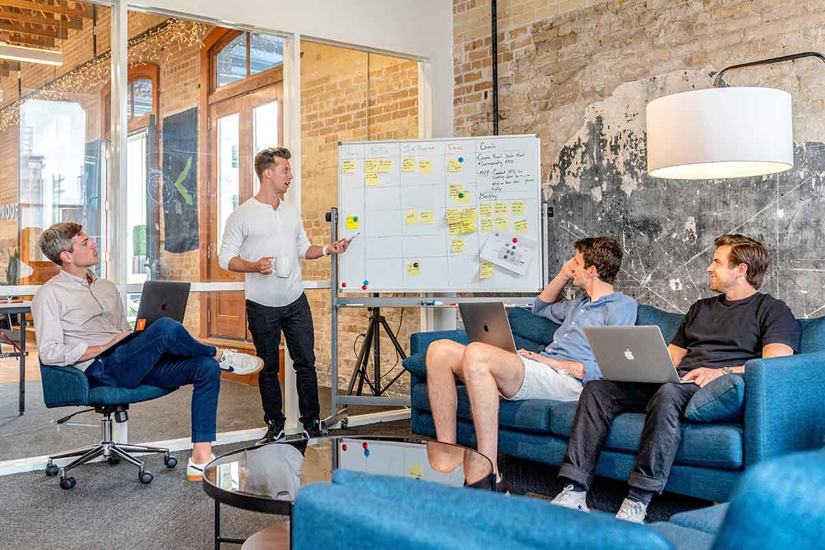a group of people in a room discussing strategy