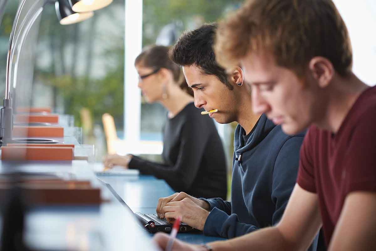 Students in a college library working