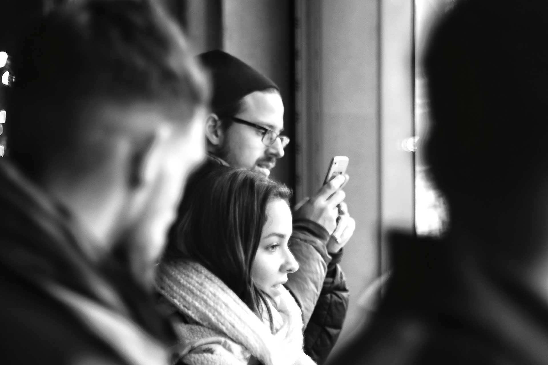 People using smartphones in urban setting. This illustrated the attention economy.